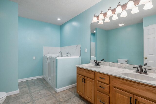 3408 Wj Robinson Rd, Cookeville, TN 38506 - full bathroom with toilet, a garden tub, baseboards, and double vanity