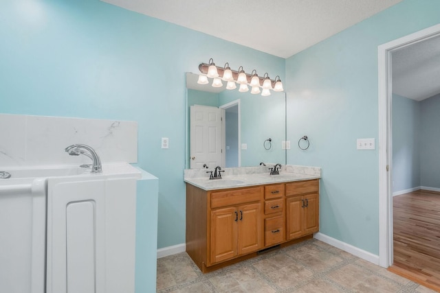 3408 Wj Robinson Rd, Cookeville, TN 38506 - bathroom with double vanity, baseboards, and a garden tub