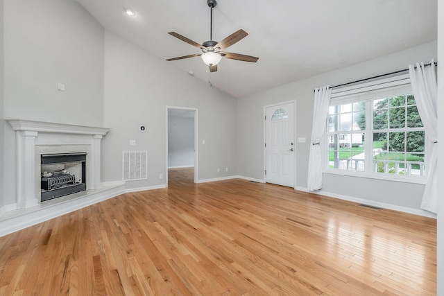 3408 Wj Robinson Rd, Cookeville, TN 38506 - unfurnished living room with ceiling fan, lofted ceiling, light wood-style flooring, baseboards, and a premium fireplace