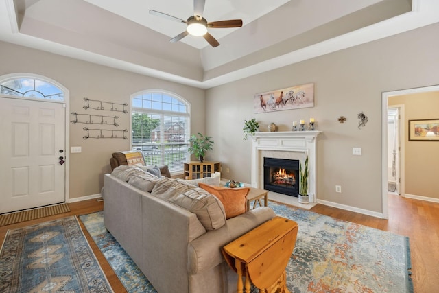 3323 Troy Rd, Lebanon, TN 37087 - living room with a raised ceiling, a ceiling fan, wood finished floors, a fireplace with flush hearth, and baseboards