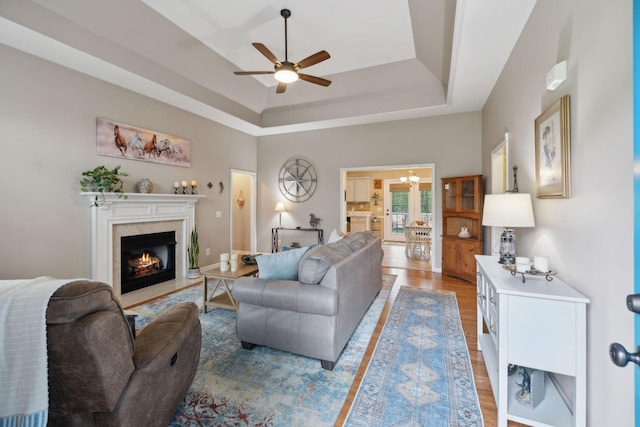 3323 Troy Rd, Lebanon, TN 37087 - living area with ceiling fan, light wood finished floors, a tray ceiling, and a high end fireplace