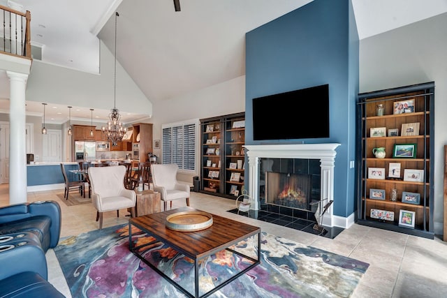 1161 Chloe Dr, Gallatin, TN 37066 - living area featuring high vaulted ceiling, a fireplace, light tile patterned floors, a chandelier, and baseboards