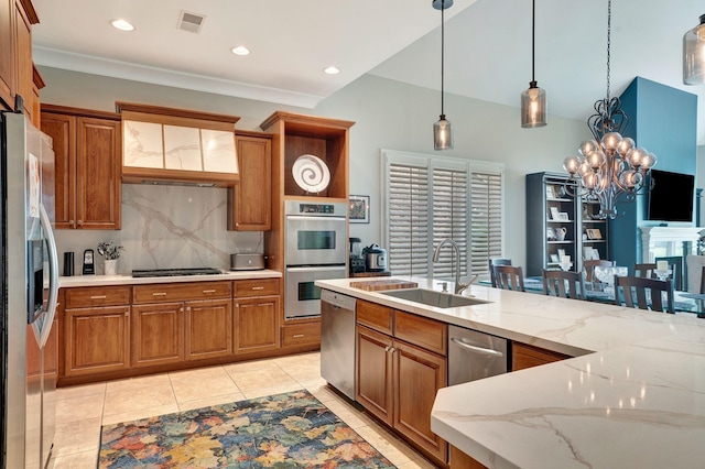 1161 Chloe Dr, Gallatin, TN 37066 - kitchen with appliances with stainless steel finishes, a sink, brown cabinetry, tasteful backsplash, and recessed lighting