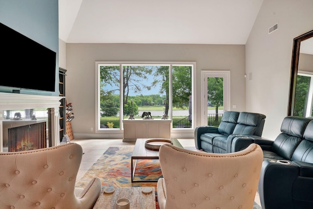 1161 Chloe Dr, Gallatin, TN 37066 - living room featuring plenty of natural light, light tile patterned floors, a high end fireplace, and high vaulted ceiling