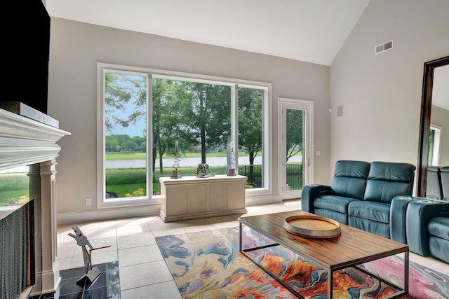 1161 Chloe Dr, Gallatin, TN 37066 - living area with healthy amount of natural light, light tile patterned floors, a water view, and high vaulted ceiling