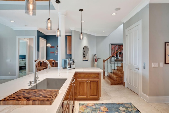 1161 Chloe Dr, Gallatin, TN 37066 - kitchen with a sink, brown cabinets, ornamental molding, light stone countertops, and light tile patterned floors