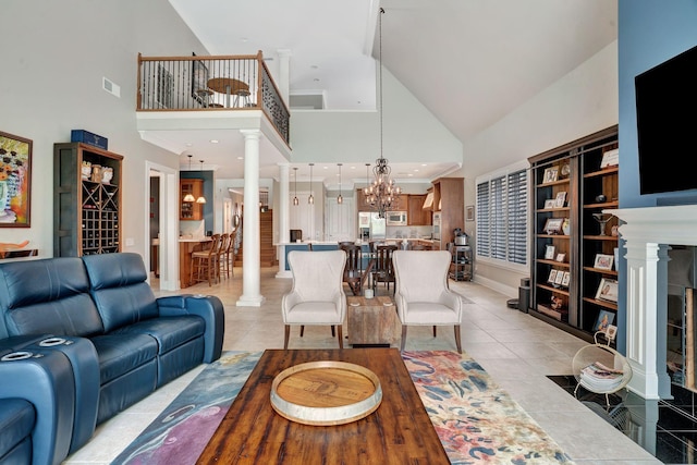 1161 Chloe Dr, Gallatin, TN 37066 - living area featuring high vaulted ceiling, ornate columns, a chandelier, light tile patterned flooring, and baseboards