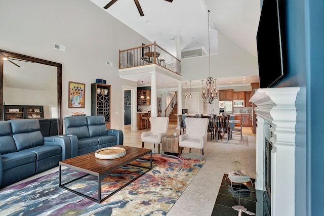 1161 Chloe Dr, Gallatin, TN 37066 - living area with a ceiling fan, high vaulted ceiling, light tile patterned flooring, a chandelier, and stairs