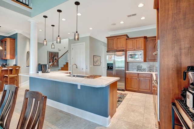 1161 Chloe Dr, Gallatin, TN 37066 - kitchen with appliances with stainless steel finishes, a sink, crown molding, brown cabinets, and a kitchen bar