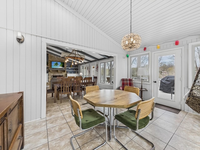 695 Bayshore Dr, Cadiz, KY 42211 - dining room with a chandelier, light tile patterned floors, wood walls, and high vaulted ceiling