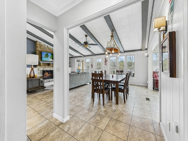 695 Bayshore Dr, Cadiz, KY 42211 - dining area with beam ceiling, a stone fireplace, light tile patterned floors, ceiling fan, and baseboards