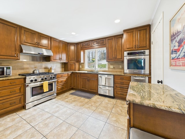 695 Bayshore Dr, Cadiz, KY 42211 - kitchen with stainless steel appliances, under cabinet range hood, decorative backsplash, brown cabinetry, and recessed lighting