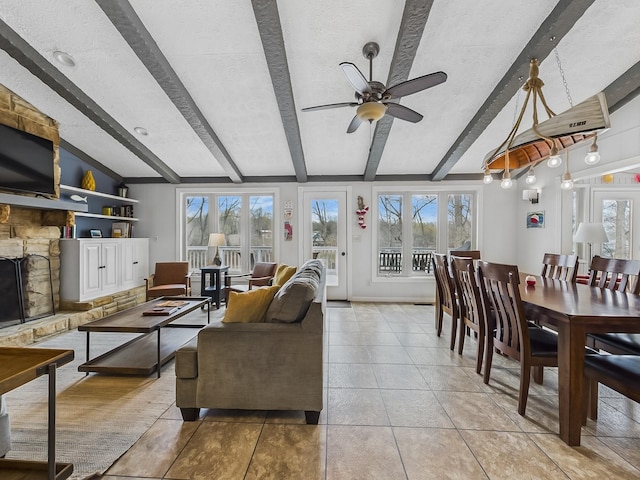 695 Bayshore Dr, Cadiz, KY 42211 - living area with healthy amount of natural light, beam ceiling, a ceiling fan, light tile patterned floors, and a textured ceiling