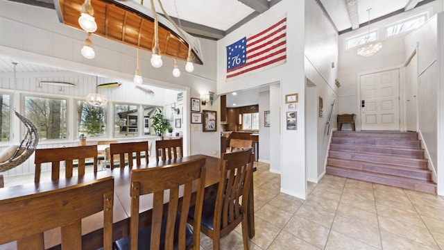695 Bayshore Dr, Cadiz, KY 42211 - dining area with stairway, light tile patterned floors, a high ceiling, beam ceiling, and baseboards