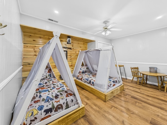 695 Bayshore Dr, Cadiz, KY 42211 - bedroom featuring wood finished floors, ornamental molding, wood walls, ceiling fan, and baseboards