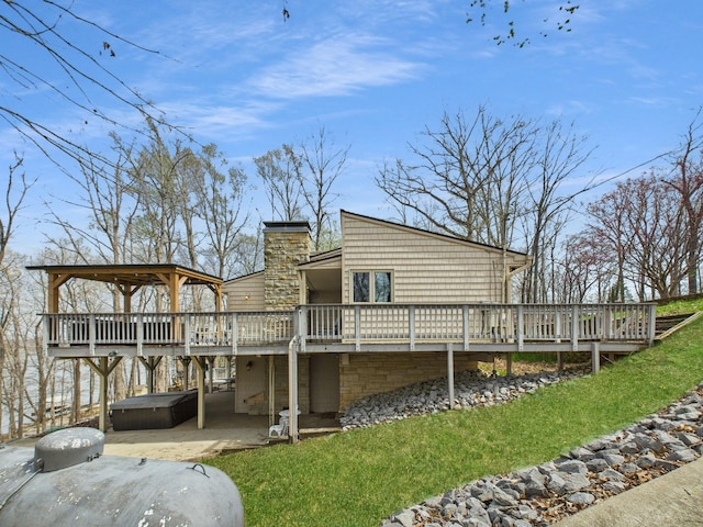 695 Bayshore Dr, Cadiz, KY 42211 - rear view of house featuring a hot tub, a deck, a patio area, a chimney, and a gazebo