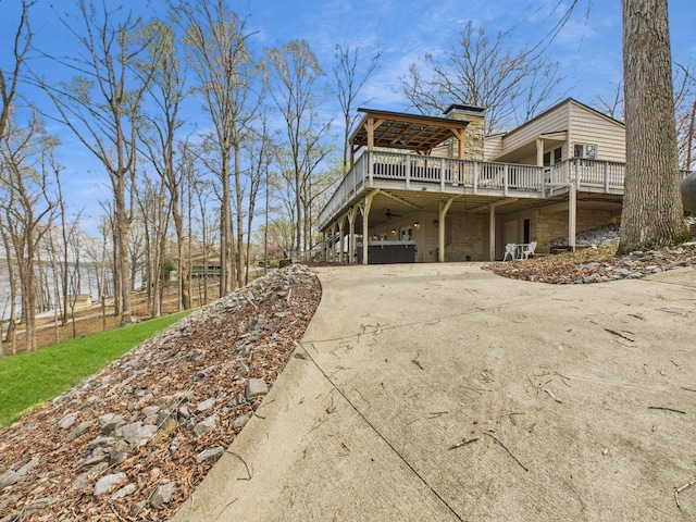 695 Bayshore Dr, Cadiz, KY 42211 - view of home's exterior featuring concrete driveway, a wooden deck, and stone siding