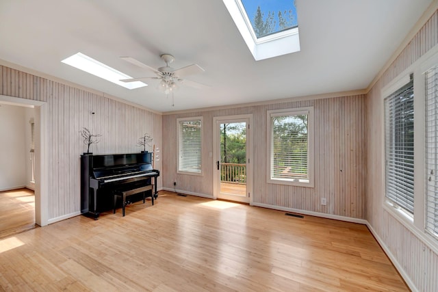 213 Andover Way, Nashville, TN 37221 - sitting room with a skylight, wood finished floors, baseboards, ceiling fan, and wood walls