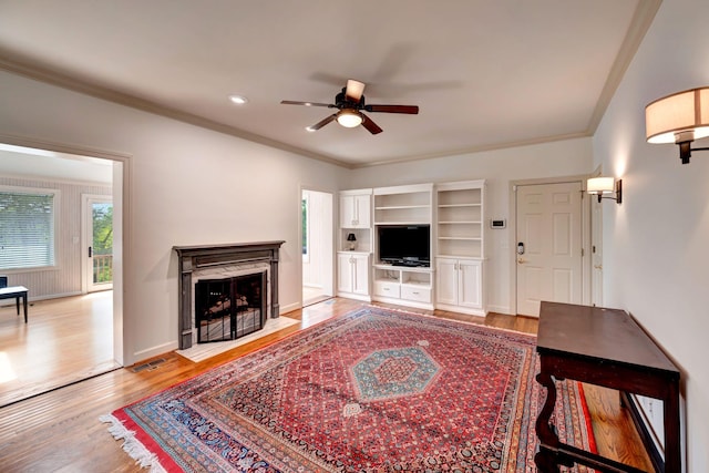 213 Andover Way, Nashville, TN 37221 - living area featuring a ceiling fan, light wood-type flooring, ornamental molding, a fireplace with flush hearth, and baseboards
