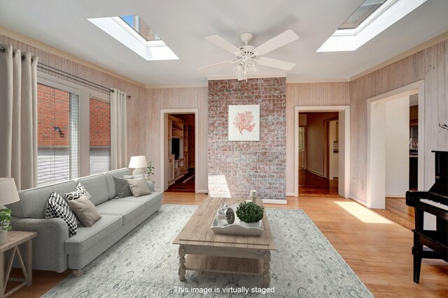 213 Andover Way, Nashville, TN 37221 - living area with a skylight, crown molding, light wood finished floors, a ceiling fan, and wood walls