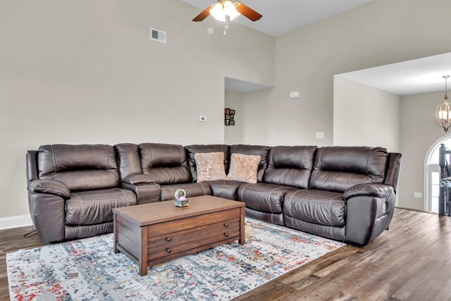 1928 Sydney Louise Dr, Clarksville, TN 37042 - living area featuring a ceiling fan, wood finished floors, a chandelier, baseboards, and a towering ceiling