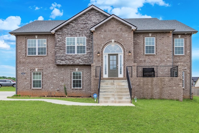 1928 Sydney Louise Dr, Clarksville, TN 37042 - view of front of home featuring brick siding, a front lawn, and roof with shingles