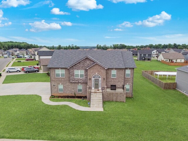 1928 Sydney Louise Dr, Clarksville, TN 37042 - traditional home with a shingled roof, a residential view, brick siding, and a front lawn