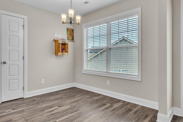 1928 Sydney Louise Dr, Clarksville, TN 37042 - unfurnished dining area with dark wood-style floors, a chandelier, and baseboards