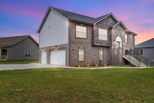 1928 Sydney Louise Dr, Clarksville, TN 37042 - view of front of house featuring brick siding, an attached garage, concrete driveway, and a front lawn