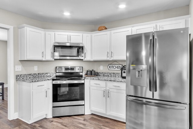 1928 Sydney Louise Dr, Clarksville, TN 37042 - kitchen with appliances with stainless steel finishes, wood finished floors, white cabinets, and recessed lighting