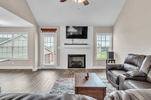 1928 Sydney Louise Dr, Clarksville, TN 37042 - living area with vaulted ceiling, ceiling fan, wood finished floors, a large fireplace, and baseboards