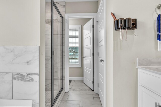 1928 Sydney Louise Dr, Clarksville, TN 37042 - bathroom featuring marble finish floors, a stall shower, vanity, and baseboards