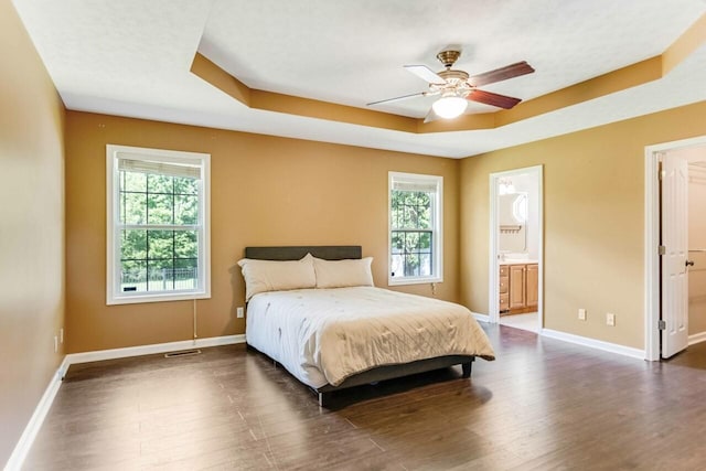991 Wing Tip Cir, Hopkinsville, KY 42240 - bedroom with a raised ceiling, multiple windows, wood finished floors, and baseboards