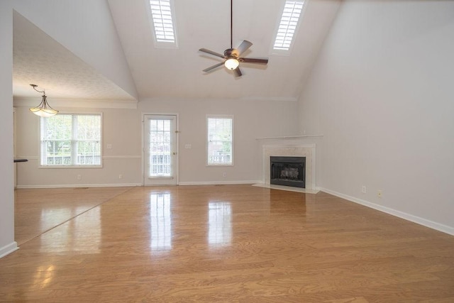 2818 Crazy Horse, Murfreesboro, TN 37127 - unfurnished living room featuring a ceiling fan, high vaulted ceiling, a high end fireplace, wood finished floors, and baseboards
