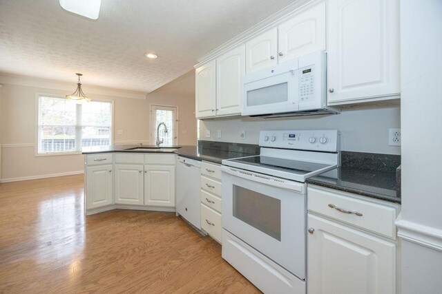 2818 Crazy Horse, Murfreesboro, TN 37127 - kitchen featuring white appliances, a sink, a peninsula, dark countertops, and white cabinetry