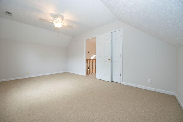 2818 Crazy Horse, Murfreesboro, TN 37127 - additional living space with lofted ceiling, light colored carpet, a ceiling fan, baseboards, and a textured ceiling