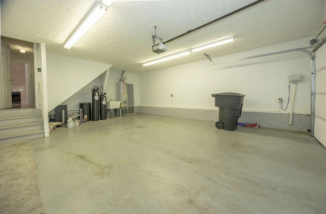 2818 Crazy Horse, Murfreesboro, TN 37127 - garage with a garage door opener, water heater, and a sink