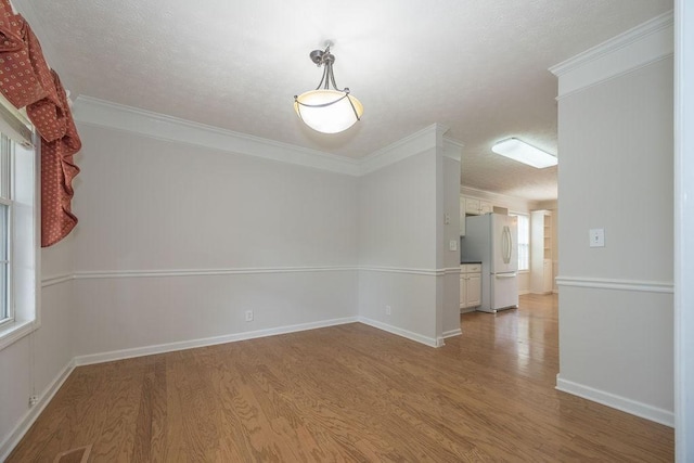 2818 Crazy Horse, Murfreesboro, TN 37127 - spare room with wood finished floors, a textured ceiling, crown molding, and baseboards