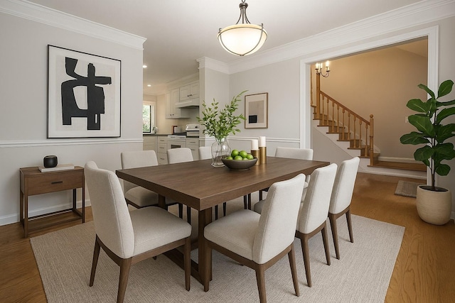 2818 Crazy Horse, Murfreesboro, TN 37127 - dining space featuring light wood finished floors, crown molding, stairs, baseboards, and a chandelier