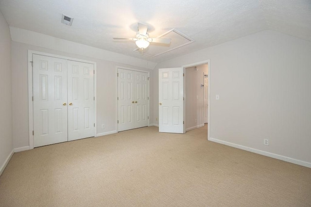 2818 Crazy Horse, Murfreesboro, TN 37127 - unfurnished bedroom featuring multiple closets, lofted ceiling, baseboards, and light carpet