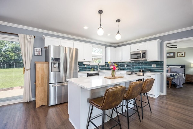 3120 Larkspur Dr, Nashville, TN 37207 - kitchen featuring stainless steel appliances, white cabinets, ornamental molding, a sink, and backsplash