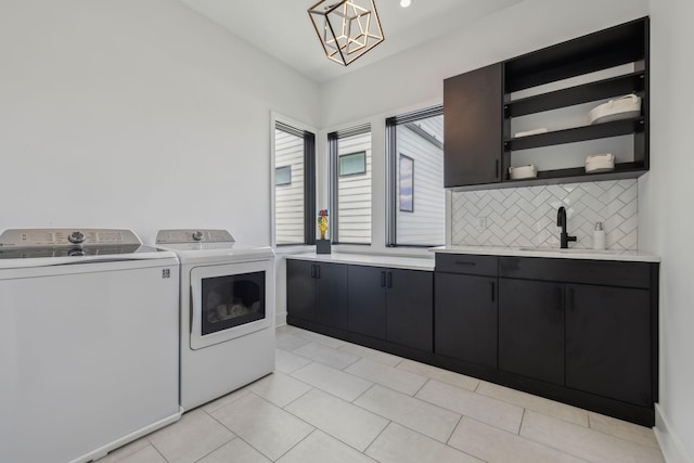 1016B 9th Ave S, Nashville, TN 37203 - laundry room with cabinet space, separate washer and dryer, a chandelier, and light tile patterned floors