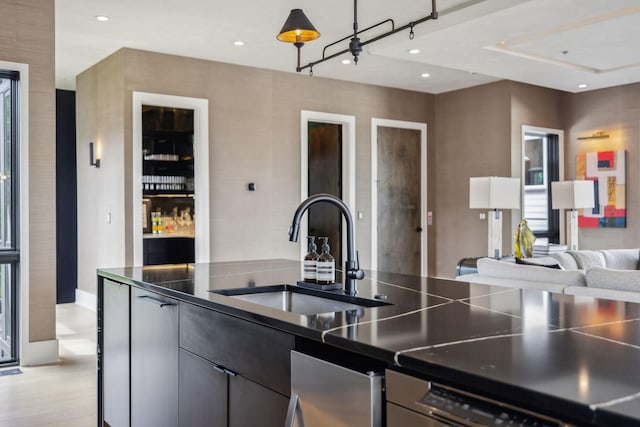 1016B 9th Ave S, Nashville, TN 37203 - kitchen featuring a sink, dark countertops, open floor plan, baseboards, and recessed lighting