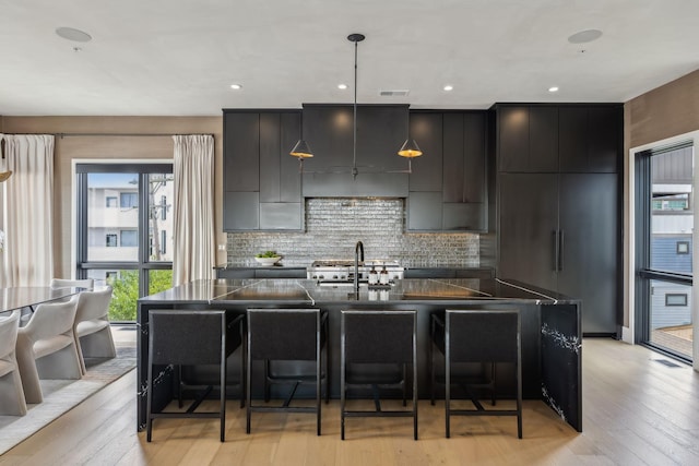 1016B 9th Ave S, Nashville, TN 37203 - kitchen featuring dark countertops, a breakfast bar area, modern cabinets, and recessed lighting
