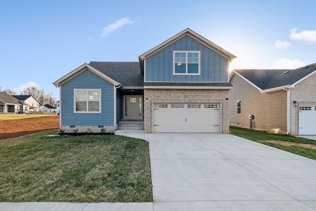 1271 Racker Dr, Clarksville, TN 37043 - view of front facade with board and batten siding, a front yard, driveway, an attached garage, and brick siding