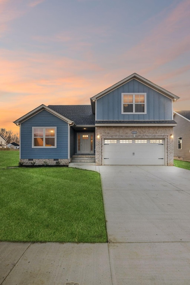 1271 Racker Dr, Clarksville, TN 37043 - view of front of property with concrete driveway, a front yard, board and batten siding, and brick siding