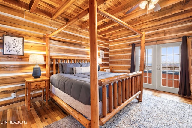 1815 Silver Poplar Ln, Sevierville, TN 37876 - bedroom with wood ceiling with exposed beams, wood walls, hardwood / wood-style floors, access to outside, and french doors