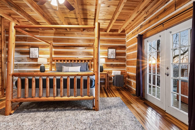 1815 Silver Poplar Ln, Sevierville, TN 37876 - bedroom featuring wood ceiling with exposed beams, wood walls, hardwood / wood-style floors, and french doors