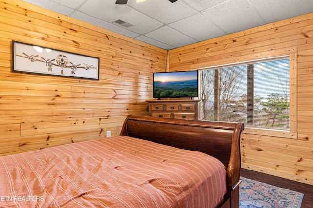 1815 Silver Poplar Ln, Sevierville, TN 37876 - bedroom with wooden walls, ceiling fan, a drop ceiling, and wood finished floors