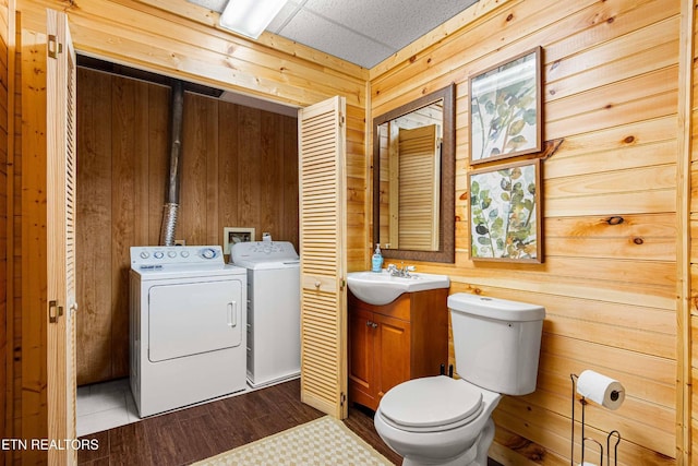 1815 Silver Poplar Ln, Sevierville, TN 37876 - half bath featuring separate washer and dryer, toilet, wooden walls, vanity, and wood finished floors
